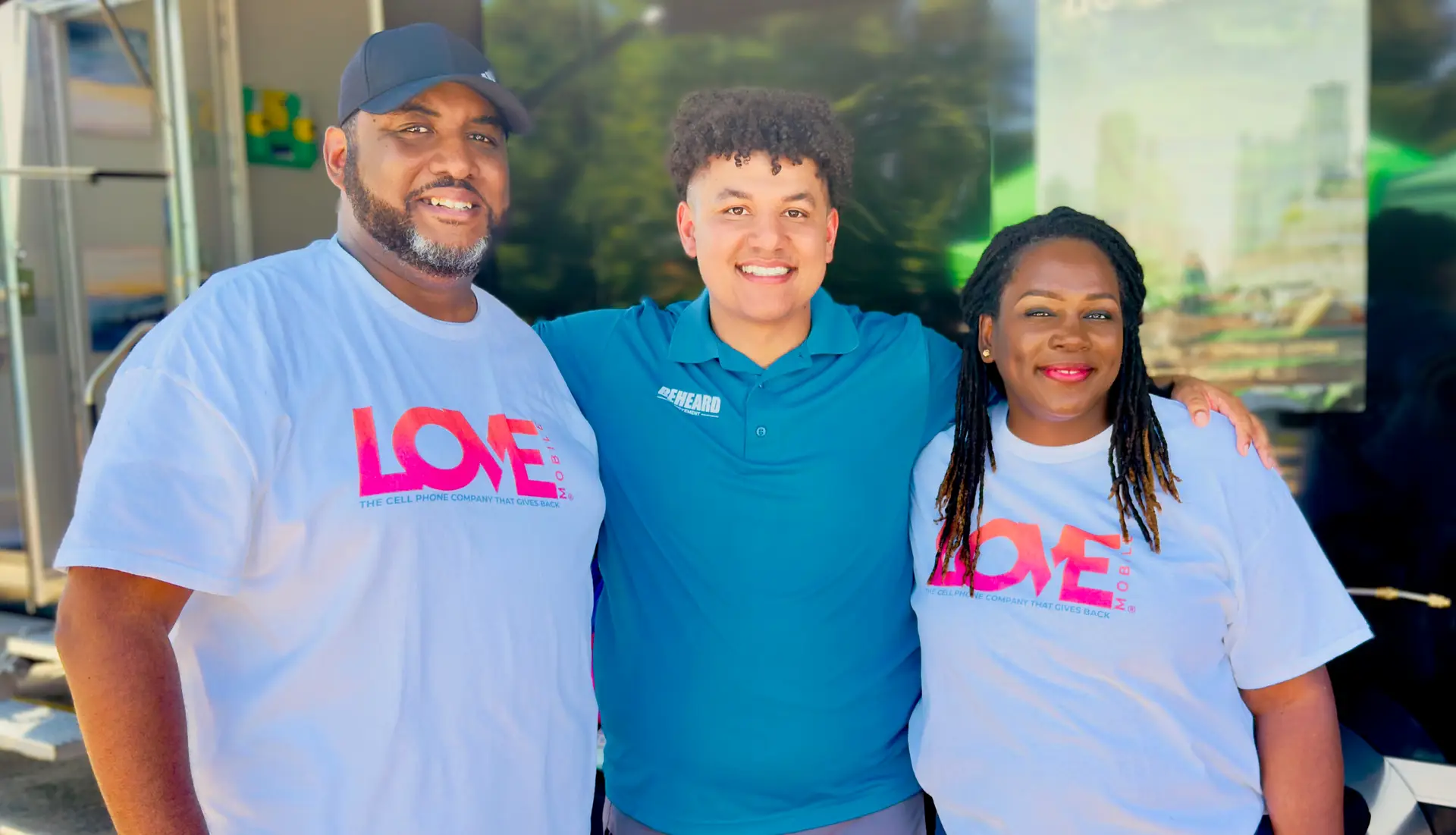 Wade Dunn and Koddi Dunn of Love Mobile with the CEO of BeHeard Movement at a community empowerment partnership event – showcasing mobile technology driving local impact.