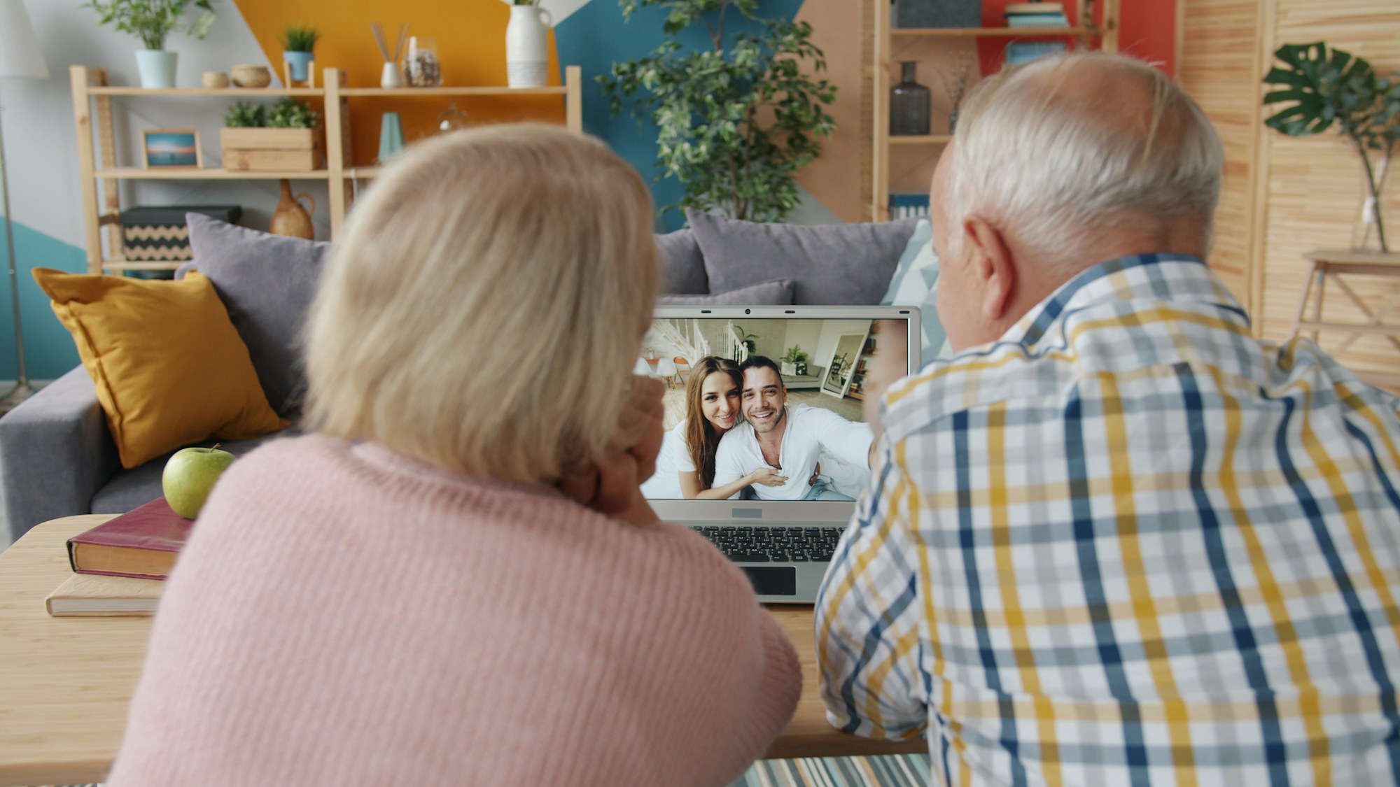 An older couple on a video call with family